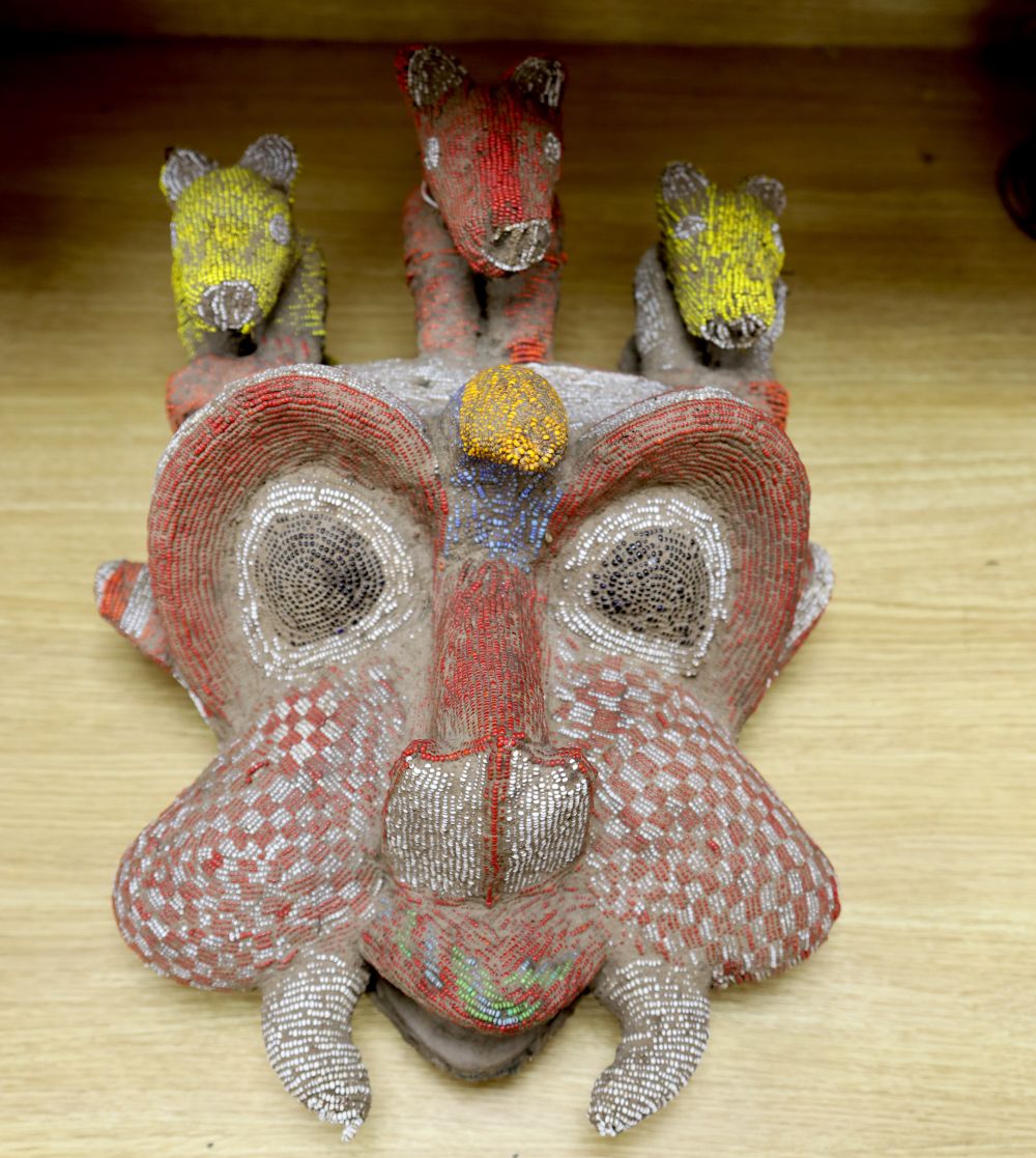 A large Bamileke tusked beadwork mask, Cameroon